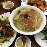 Seafood noodles, banana tomato dish, fried cauliflower and broccoli  at Hà Thành in Hanoi