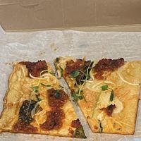 This was the vegan slice special yesterday- vegan mozz, pea shoots, salsa Rosa, and some other goodness. Uniquely delicious!!  at Monte's Fine Foods in Portland