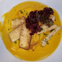 Grilled tofu and polenta with special sauce at Napfényes Restaurant & Confectionery in Budapest
