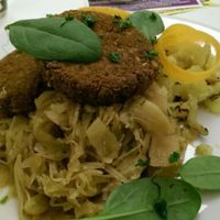Hungarian Oat Fritters with 
Braised Cabbage and Potatoes at Napfényes Restaurant & Confectionery in Budapest