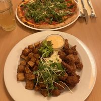 Pesto cashew Parmesan Pizza, seitan Nuggets platter   at Napfényes Restaurant & Confectionery in Budapest
