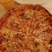Hawaii pizza with no corn and extra onion at Napfényes Restaurant & Confectionery in Budapest