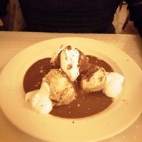 Sponge cake with chocolate sauce and whipped cream. at Napfényes Restaurant & Confectionery in Budapest