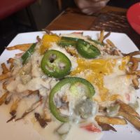 Fries covered in cheese and jalapeños   at Souley Vegan in Oakland