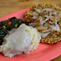 Mashed potatoes, sauteed chard, fried seitan & caramelized  onion. Delicious, but on the oily side. at Souley Vegan in Oakland