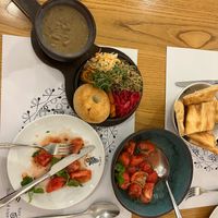 Lobio (beans in a clay pot), tomato salad with pickled jonjoli (buds of the caucasian bladdernut), house bread. at Salobie Bia in Tbilisi