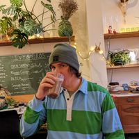 Hot chocolate with espresso, menu behind. at Ivy and Bros in Amsterdam