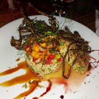 Main: quinoa salad with tomato, avocado and mango, vegetable burger, garnished with fried algae at Pininga in Atins