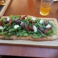 Flatbread with rucola and sun-dried tomatoes at Blu Bar in Barcelona
