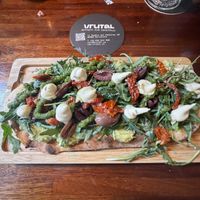 Flatbread with avocado, sundried tomato, olives, arugula, and a creamy "cheese”  at Blu Bar in Barcelona