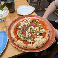 Stracciatella pizza with tomato sauce, vegan stracciatella cheese, pistachios and basil oil at Blu Bar in Barcelona