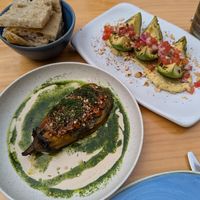 "Berenjena gourmet": roasted eggplant, peanut sauce, tahini sauce, mixed seeds and dill + "Next level avocado: toasted avocado, served with hummus, tomato, red onion, Tajín Clási at Blu Bar in Barcelona