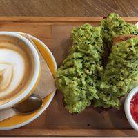 Tostada with avocado and tomato. Oat milk latte at Dulce de Leche - Boutique San Vicente in Valencia