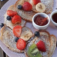 Pancakes with maple syrup, fruit and confiture at Cytat Cafè in Krakow
