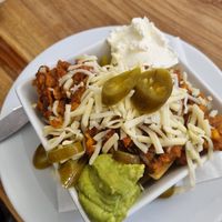 Vegetarian sweet potato and lentil chilli nachos. Can be made VG without the cheese and sour cream at Laggan Wolftrax Cafe in Laggan