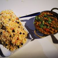 Yellow lentils Dahl, basmatic rice with dried fruits at Jaipur Palace in Sevilla