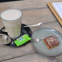Chai latte with oat milk and chocolate and caramel slice 😋 at Het Kantongerecht in Boxmeer