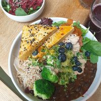 Black bean rice bowl with tofu and kimchi salad on the side at Nude Food in Augsburg