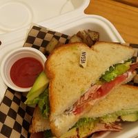 Vegan and crispy BLT with added breakfast potatoes. Love the "Vegan" toothpick! at Lively Up Yourself - Food Truck in Bend