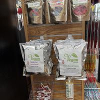 Small bags of pop corn toward the lower end of the column with the vegan chocolate bar and some yum earth lollipops and sour patch kids, Swedish fish and jelly belly gummies  at Van Holten's Sweet Shop in Seaside Heights