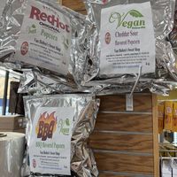4 oz popcorn bags at the top of the column (franks red hot, cheddar sour and BBQ)  at Van Holten's Sweet Shop in Seaside Heights