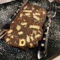 Intense chocolate dessert with digestive crackers in side   at Buns in Alghero