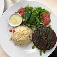 Beetroot and bean burger with vegetables rice and salad   at Mela Canela in Sintra