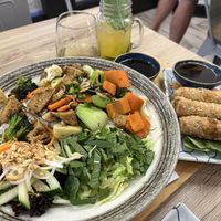Vegan vermicelli bowl and vegan crispy spring roll with a glass of white wine and mojito   at Hello Me in Mooresville