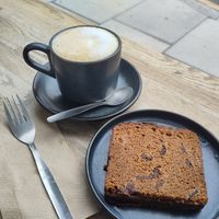 Oat milk cappuccino and banana bread at Cinnamon Coffee Shop in London