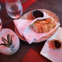 Bread basket with olive tapenade & vegan holiday cocktail at Lamoraga in Naples