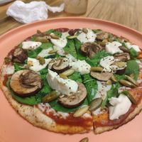 The pizza with vegan cheese, vegan cream cheese on top with moshrooms and spinach at Veggie 2 Go in Cancun
