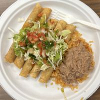 potato taquitos with beans and rice and toppings (party pack catering order)  at El Tianguis in San Diego