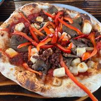 Custom vegan pizza with red peppers, caramelized onions, vegan feta, and vegan sausage.  at The Privateer in Oceanside