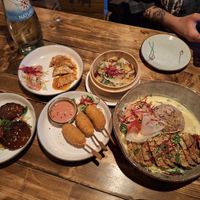 Caramel sauce over dumplings, braised beef, prawn sticks, peanut mock duck at Element Five in Berlin