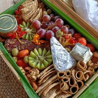 Cheese board with fruits, nuts and vegan ham. at TreeNut Cheezery in Ubud