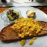 Tofu scramble on sourdough bread, avocados and vegan butter at Tiffin Cafe in Lisbon