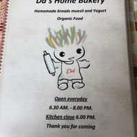 Menu front with hours at Da's Home Bakery in Chiang Mai