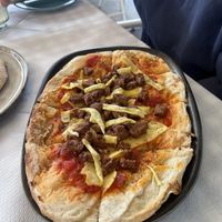 Vegan pizza (slices of cheese with cut up vegan burger patty )  at Cafe12 in Crete