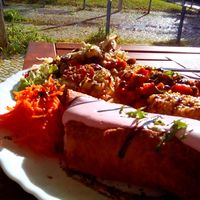 Outdoors tables near a green area at Vegan Story in Lisbon
