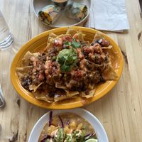 Top to bottom: Spring Rolls, Nachos, and Crispy Cauliflower Taco  at Veggie Grill by Next Level in Cambridge