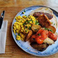 Tofu scramble with tempeh bacon, vine tomatos, potatoes and sourdough bread at Greens & Co in Galway