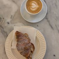 Almond croissant and oat latte at Mica Coffeebar in Haarlem