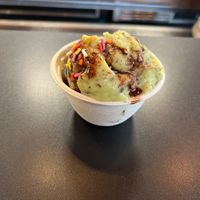 Mint chocolate chip with chocolate sauce and sprinkles   at Bliss Scoop Shop in University Place
