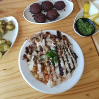 hummus with loads of toppings and falafel on the side at Tahini's Hummus in Beer Sheva