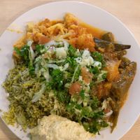 Buffet selection, $14 medium plate - herb rice, okra stew, cauliflower stew, salad and hummus at Eden Iranian Fusion Eatery in Wellington