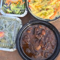 Mushroom oxtail, sautéed okra, rasta pasta, salad at Toma-Tis in Elmont