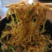 Impossible Dan Dan Noodles touched to show noodles at Fatt Root in Pleasantville