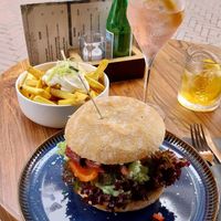 Burger with 3d-printed steak, truffel fries, and aperol no-spritz. at New Vegas in Haarlem