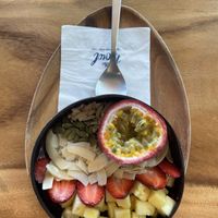 Customised (build your own bowl) version: frozen berry mix base and 6 toppings by own choice. Here are: passion fruit, strawberry, pineapple, coconut chips, pumpkin seeds, almond.  at Hosay Bowl in Phuket