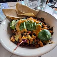 Mexican Hash: tofu scramble, soyrizo, grilled potatoes, onions, red peppers, black beans, Kale greens, arugula, avo slices, corn tortillas 😋 at Vegan Avenue in San Antonio